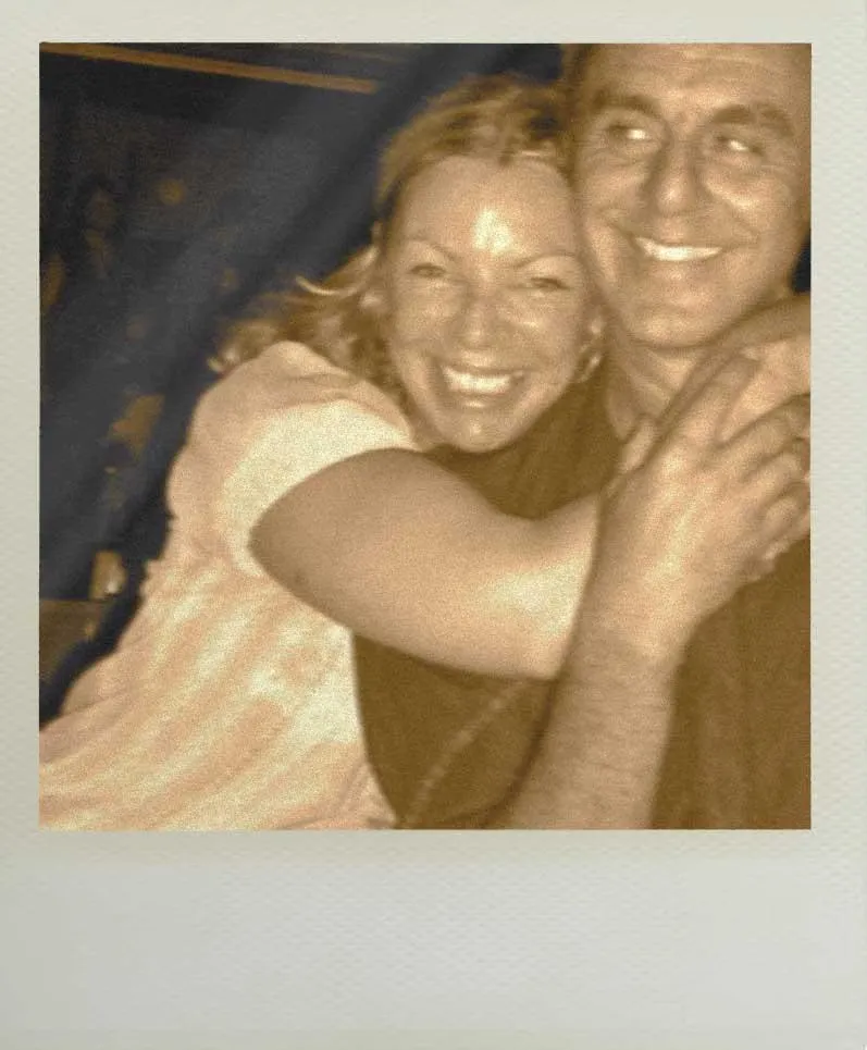Polaroid of Eftihis and his wife Carline, embracing and smiling together.